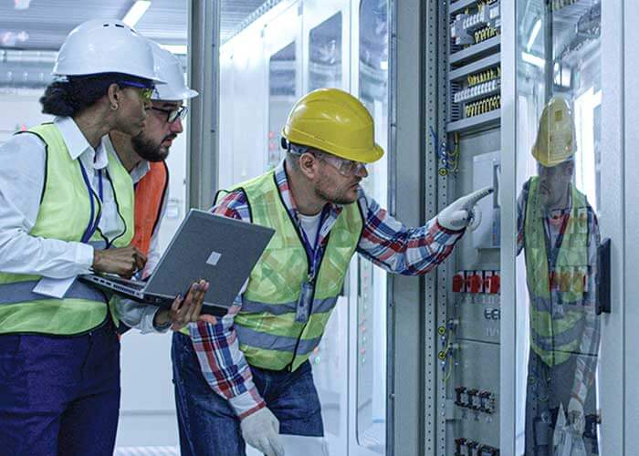 Three engineers in a data center.